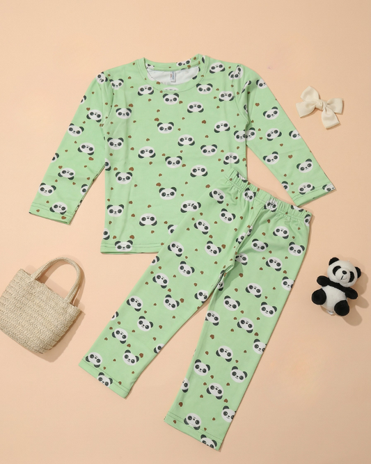 Green pajama set with panda pattern on a beige background