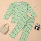 Green pajama set with panda pattern on a beige background